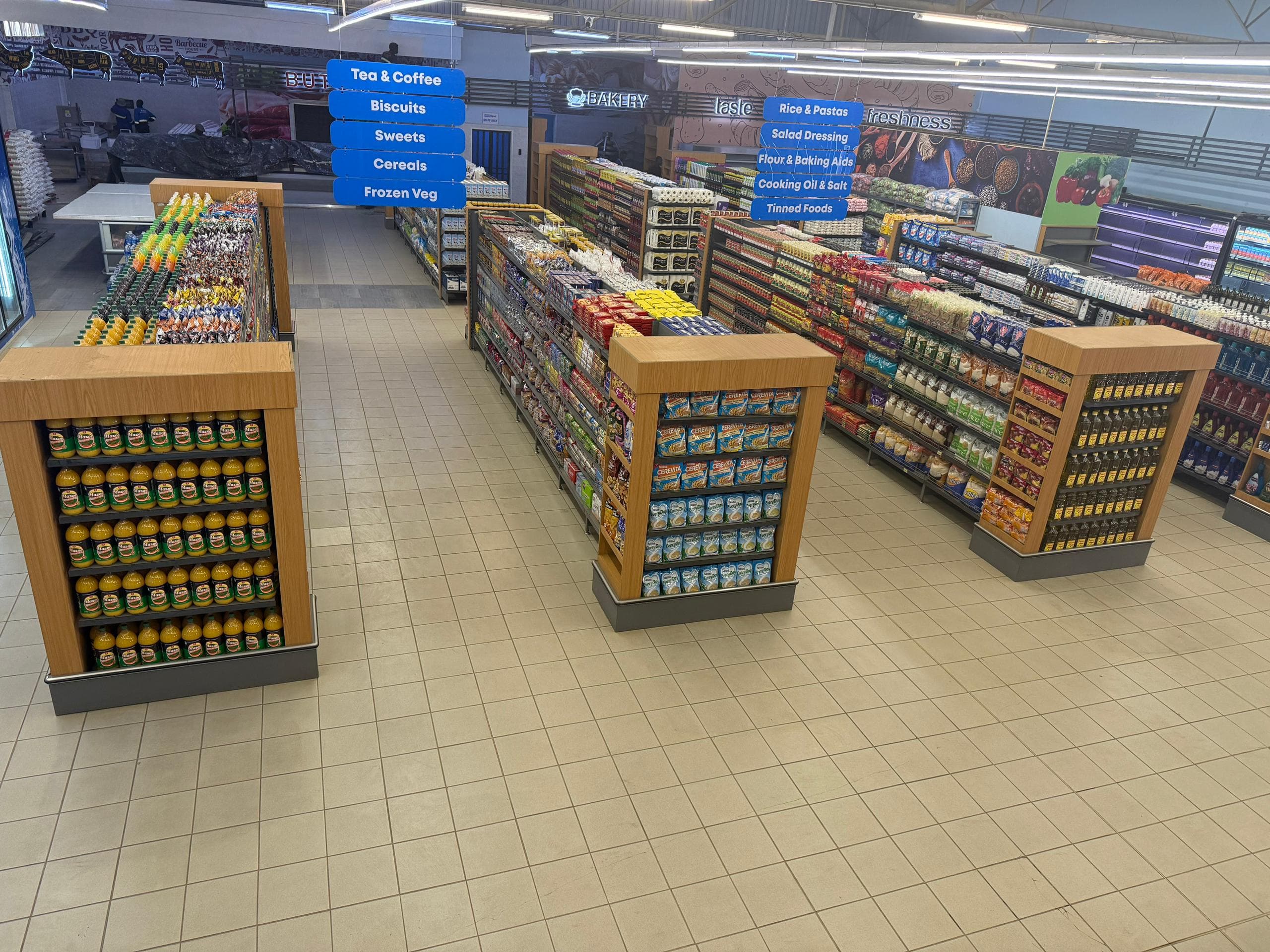 The shop floor of the PrevailMart Mazowe branch, showing stocked end-caps and aisles.